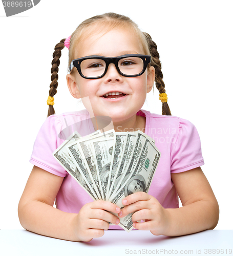 Image of Little girl is counting dollars