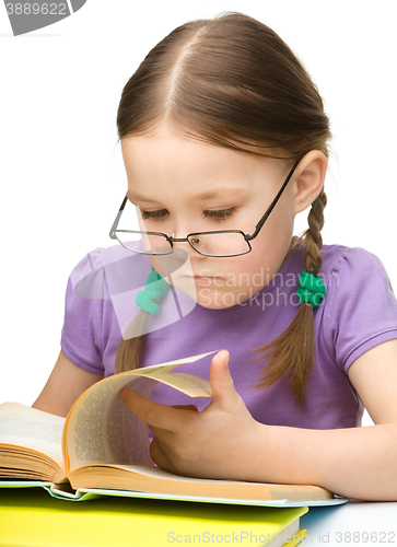 Image of Little girl is reading a book