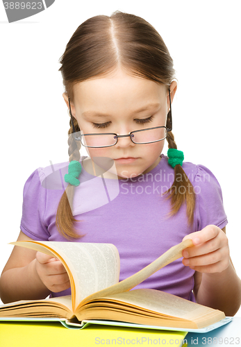 Image of Little girl is reading a book