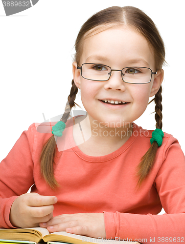 Image of Little girl is reading a book