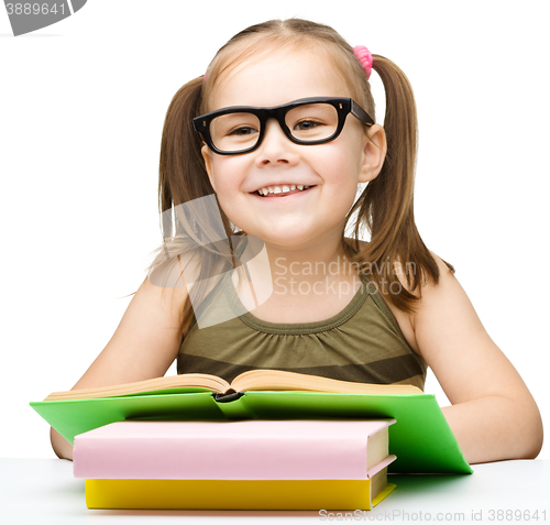 Image of Little girl is reading a book