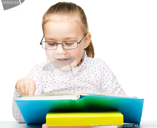 Image of Little girl is reading a book