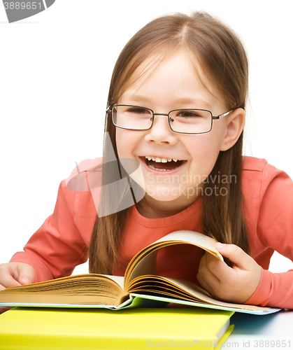 Image of Little girl is reading a book