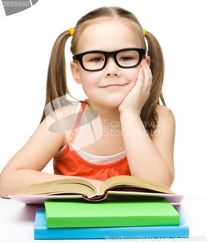 Image of Little girl is reading a book