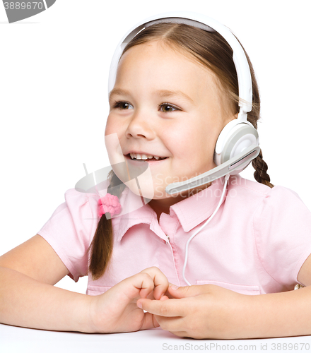 Image of Young girl is working as an operator at helpline