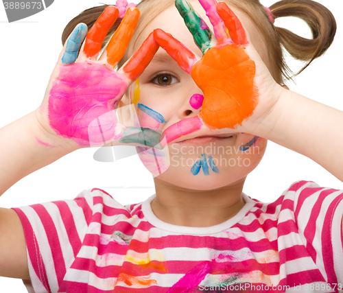 Image of Portrait of a cute girl playing with paints