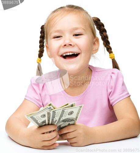 Image of Little girl with dollars