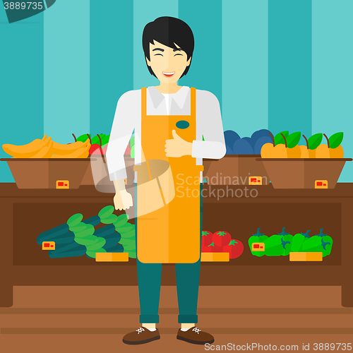 Image of Supermarket worker with box full of apples.