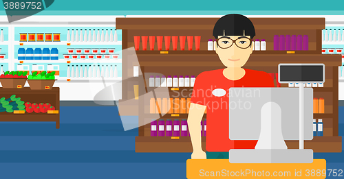 Image of Salesman standing  at checkout.