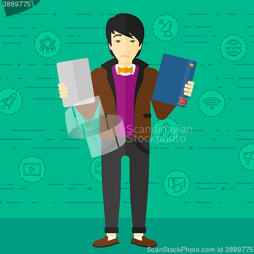 Image of Man choosing between book and tablet computer.
