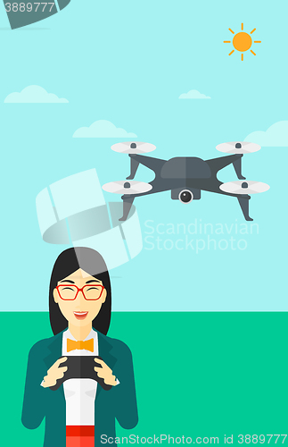 Image of Woman flying drone.