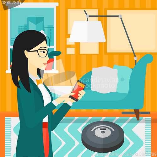 Image of Woman with robot vacuum cleaner.