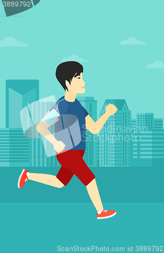 Image of Man jogging with earphones and smartphone.