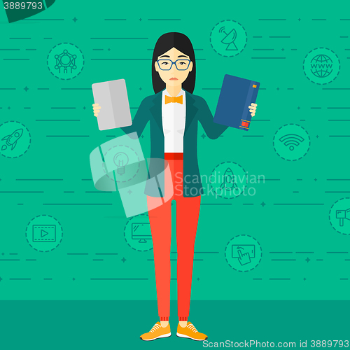 Image of Woman choosing between book and tablet computer.