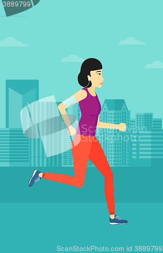 Image of Woman jogging with earphones and smartphone.
