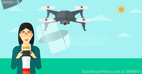 Image of Woman flying drone.