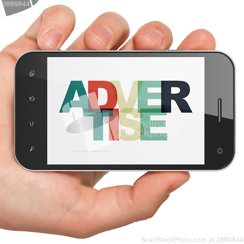 Image of Advertising concept: Hand Holding Smartphone with Advertise on  display