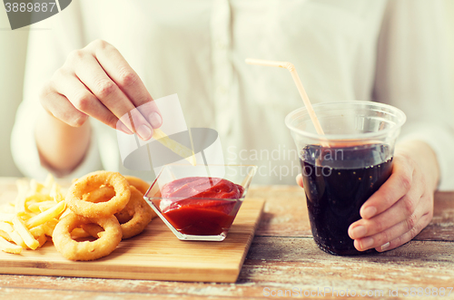 Image of close up of woman with snacks and cocacola