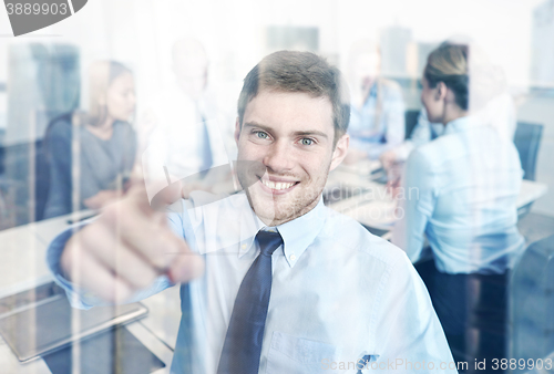 Image of group of smiling businesspeople meeting in office