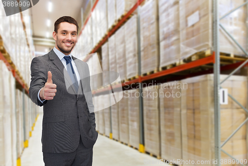 Image of happy man at warehouse showing thumbs up gesture