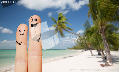 Image of close up of two fingers with smiley faces