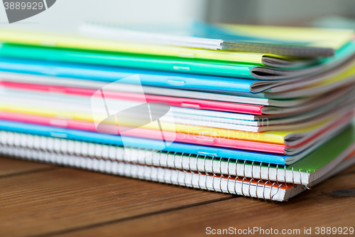 Image of close up of notebooks on wooden table