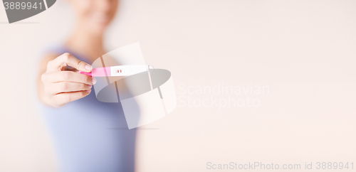 Image of happy woman with pregnancy test