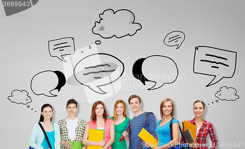 Image of group of teenage students with folders and bags