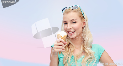 Image of happy young woman in sunglasses eating ice cream