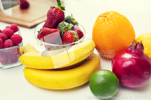 Image of close up of fresh fruits and berries on table