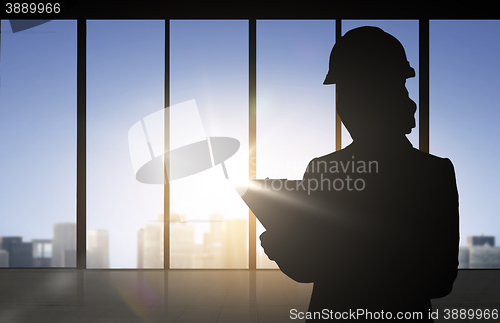 Image of silhouette of woman in helmet with clipboard