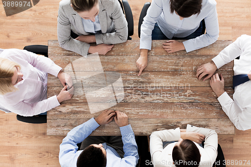 Image of close up of business team sitting at table