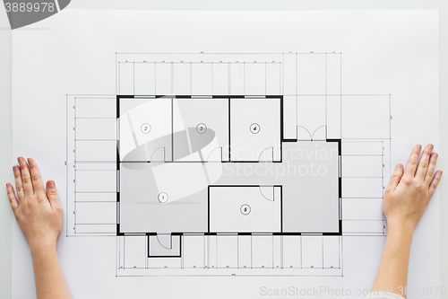 Image of close up of hands with architectural blueprint