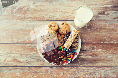 Image of close up of sweet food and milk glass on table