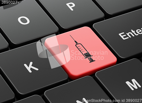 Image of Medicine concept: Syringe on computer keyboard background