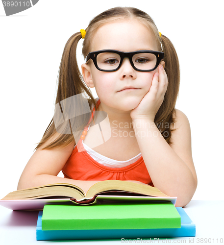 Image of Little girl is reading a book