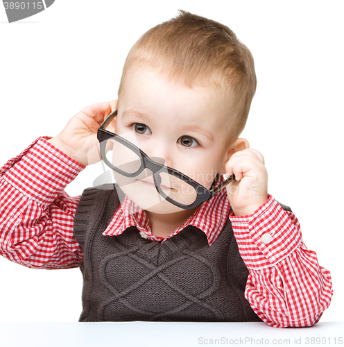 Image of Portrait of a cute little boy wearing glasses