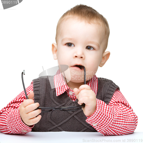 Image of Little child play with book