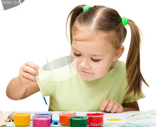 Image of Cute cheerful child play with paints