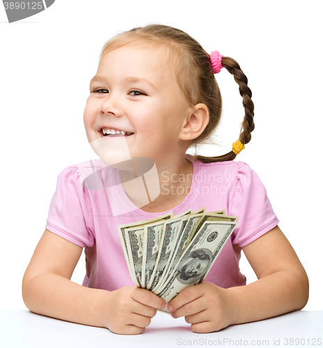 Image of Little girl with dollars