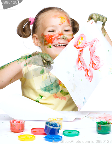 Image of Portrait of a cute girl playing with paints