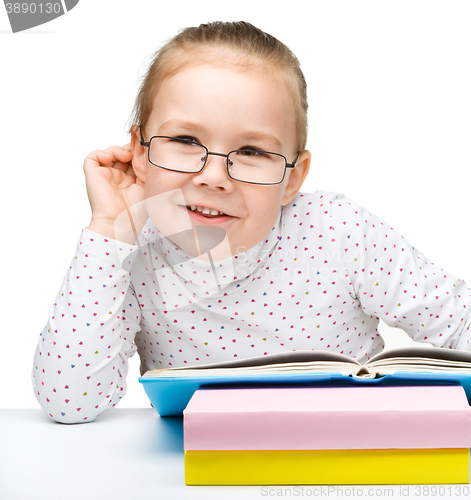 Image of Little girl is reading a book