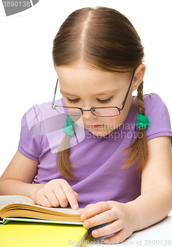 Image of Little girl is reading a book