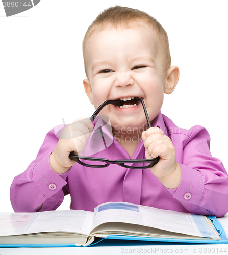 Image of Little child play with book