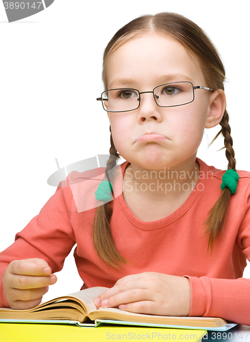 Image of Little girl is reading a book