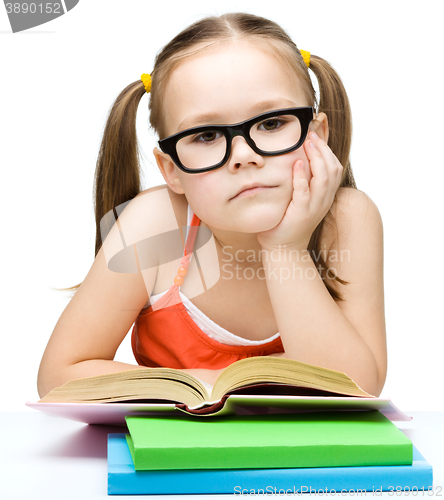 Image of Little girl is reading a book