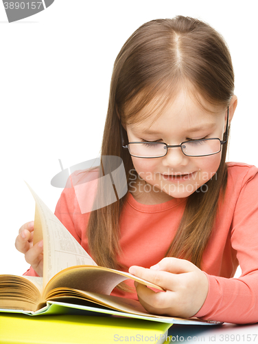 Image of Little girl is reading a book