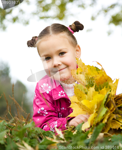 Image of Portrait of a little girl in autumn park