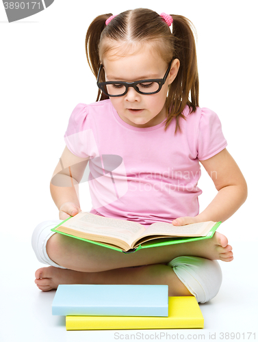 Image of Little girl is reading a book