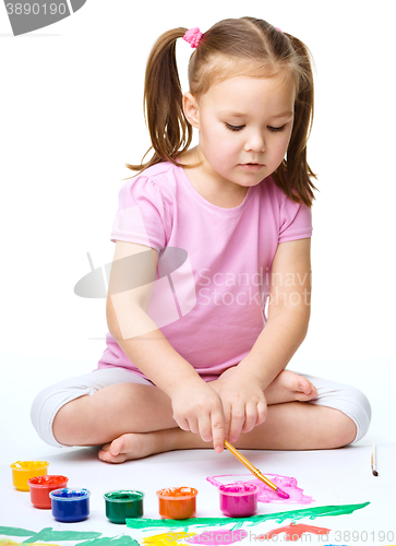 Image of Cute cheerful child play with paints